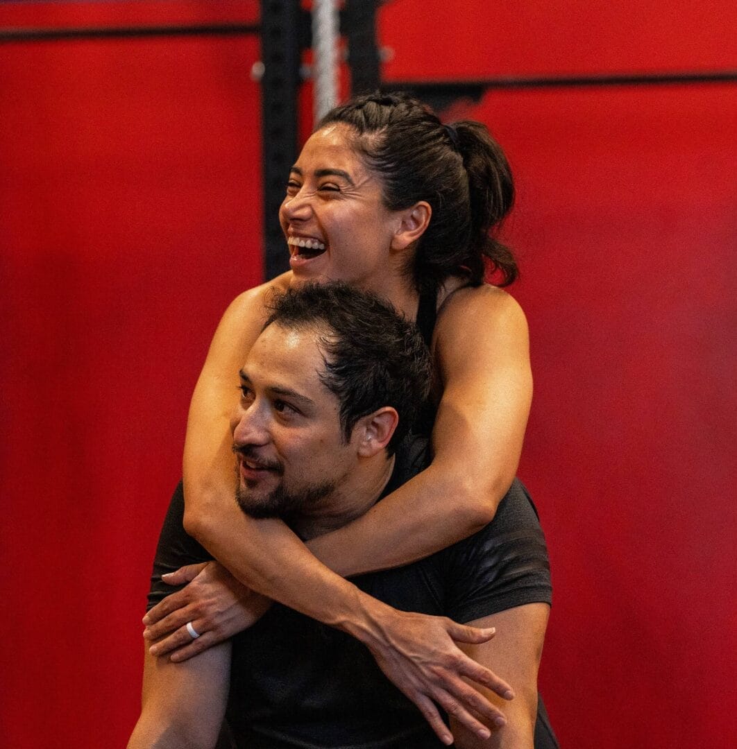 Man and woman hugging in Crossfit gym